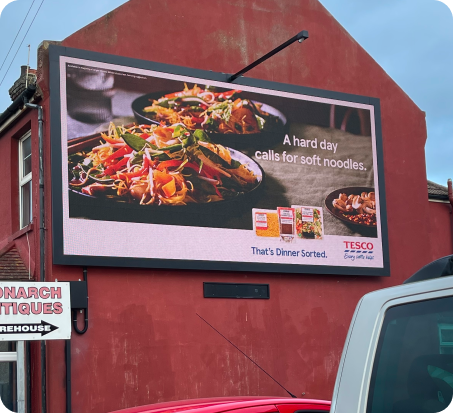 Digital signage in retail store showcasing promotions and product advertisements.
