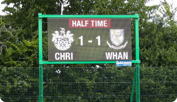 LED scoreboard mounted on perimeter fence for fieldside viewing.