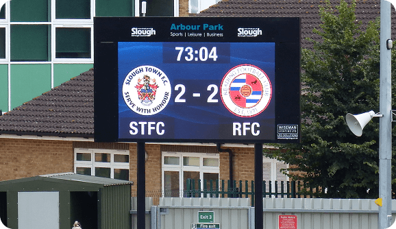 LED scoreboard installed with permanent concrete base for stability.