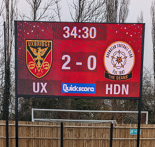 LED sports scoreboard displaying live football match scores with custom game control software.