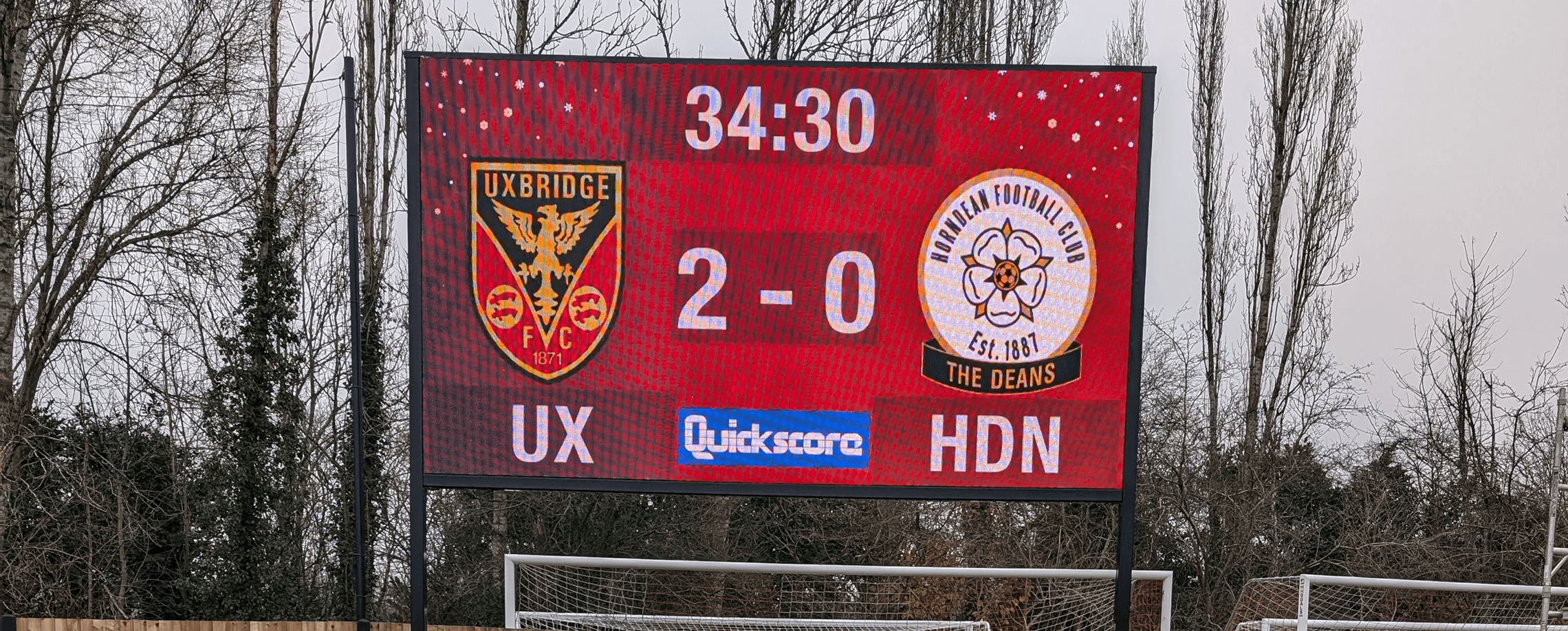 LED sports scoreboard displaying live football match scores with custom game control software.